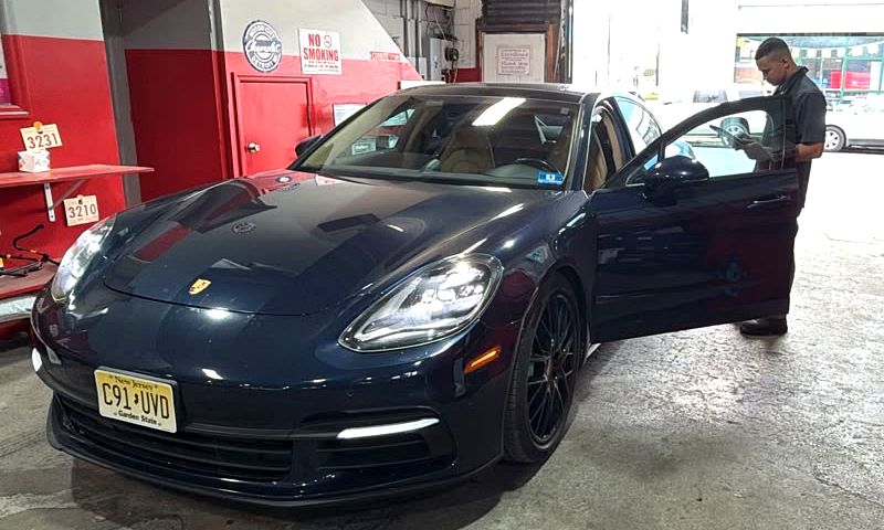 Porsche Panamera being checked in by a technician